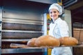 Baker woman showing freshly baked bread on shovel Royalty Free Stock Photo