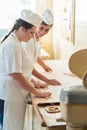 Baker women working in bakehouse of bakery