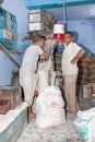 bakerman fills flour in the machine to bake bread Royalty Free Stock Photo