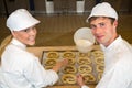 Bakers in bakery producing pretzels