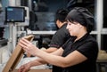 Bakers in black uniform at the pizzeria kitchen working on order Royalty Free Stock Photo