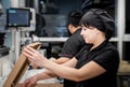 Bakers in black uniform at the pizzeria kitchen working on order