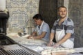 Bakers knead the dough for baking pita bread