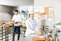 Bakers Smiling In Commercial Kitchen Royalty Free Stock Photo