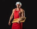Bakery advertising. Cooking and baking. Chef baker man in apron. Sexy guy with bread and knife.