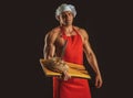 Bakery advertising. Cooking and baking. Chef baker man in apron. Sexy guy with bread and knife. Royalty Free Stock Photo