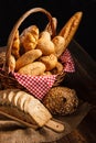 Bakery Assortment on wooden table on dark background. Still Life of variety of bread with natural morning light