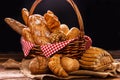 Bakery Assortment on wooden table on dark background. Still Life of variety of bread with natural morning light