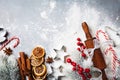 Bakery background for cooking christmas baking with rolling pin, scattered flour and spices decorated with fir tree top view.