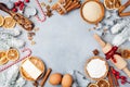 Bakery background with ingredients for cooking christmas baking decorated with fir tree. Flour, brown sugar, eggs and spices. Royalty Free Stock Photo