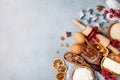 Bakery background with ingredients for cooking christmas baking decorated with fir tree. Flour, brown sugar, eggs and spices. Royalty Free Stock Photo