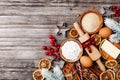 Bakery background with ingredients for cooking christmas baking decorated with fir tree. Flour, brown sugar, eggs and spices.