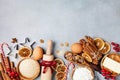 Bakery background with ingredients for cooking christmas baking decorated with fir tree. Flour, brown sugar, eggs and spices. Royalty Free Stock Photo