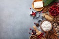 Bakery background with ingredients for cooking Christmas baking. Flour, brown sugar, butter, cranberry and spices on table top