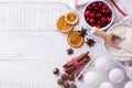 Bakery background with ingredients for cooking Christmas baking. Flour, brown sugar, cranberry and spices top view Royalty Free Stock Photo