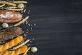 Bakery background top view. Crusty buns and loaves of bread on dark grey chalkboard background