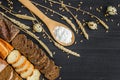 Bakery background top view. Crusty buns and loaves of bread on dark grey chalkboard background