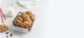 Bakery banner. Healthy oatmeal cookies in basket and a bottle of milk on light concrete background. Flour free oatmeal cookies