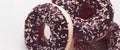 Frosted sprinkled donuts, sweet pastry dessert on marble table background, doughnuts as tasty snack, top view food brand flat lay