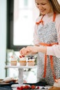 Bakery Chef woman decorating cupcakes on serving platter Royalty Free Stock Photo