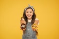 Bakery and confectionery concept. Kid girl hold glazed muffins. Delicious cupcakes. Happy childhood. Adorable smiling