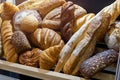 A bakery counter with an array of bread loaves, rolls, and baguettes Royalty Free Stock Photo