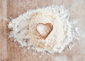 .Bakery flour in kitchen, wood texture table and cooking dessert with heart cookie cutter. Love pastry in wheat cake Royalty Free Stock Photo