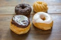 Bakery fresh doughnuts soft and sweet delicious glazed frosted donuts variety on wood table surface