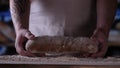 In the bakery, the hands of the baker are seen very closely as he prepares various flour products in an apron, after which he lays Royalty Free Stock Photo