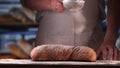 In the bakery, the hands of the baker are seen very closely as he prepares various flour products in an apron, after which he lays Royalty Free Stock Photo