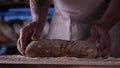 In the bakery, the hands of the baker are seen very closely as he prepares various flour products in an apron, after which he lays Royalty Free Stock Photo