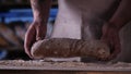 In the bakery, the hands of the baker are seen very closely as he prepares various flour products in an apron, after which he lays Royalty Free Stock Photo