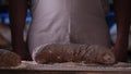 In the bakery, the hands of the baker are seen very closely as he prepares various flour products in an apron, after which he lays Royalty Free Stock Photo