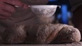 In the bakery, the hands of the baker are seen very closely as he prepares various flour products in an apron, after which he lays Royalty Free Stock Photo