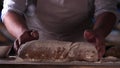 In the bakery, the hands of the baker are seen very closely as he prepares various flour products in an apron, after which he lays Royalty Free Stock Photo