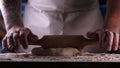 In the bakery, the hands of the baker are seen very closely as he prepares various flour products in an apron, after which he lays Royalty Free Stock Photo