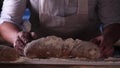 In the bakery, the hands of the baker are seen very closely as he prepares various flour products in an apron, after which he lays Royalty Free Stock Photo