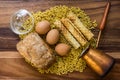 Bakery ingredients - bread, wafer rolls, pasta and eggs on wood table. Sweet pastry baking concept. copy space, top view.