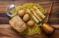 Bakery ingredients - bread, wafer rolls, pasta on wood table. Sweet pastry baking concept. Flat lay, copy space, top view.