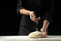 Bakery. Man preparing the bread, Easter cake, Easter bread or cross buns on a wooden table in the bakery close up. Cook preparing Royalty Free Stock Photo