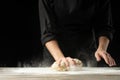 Bakery. Man preparing the bread, Easter cake, Easter bread or cross buns on a wooden table in the bakery close up. Cook preparing Royalty Free Stock Photo