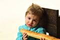 Bakery shop concept. Little boy with french baguette in bakery shop. Cute child with fresh bread in bakery shop. Bakery