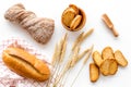 Bakery set with fresh wheaten bread on table white background top view