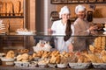 Bakery staff offering bread Royalty Free Stock Photo