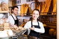 Bakery staff offering bread and different pastry Royalty Free Stock Photo