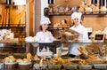 Bakery staff offering bread and different pastry Royalty Free Stock Photo