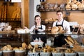 Bakery staff offering bread and different pastry Royalty Free Stock Photo