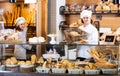 Bakery staff offering bread and different pastry Royalty Free Stock Photo