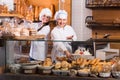 Bakery staff offering bread and different pastry for sale Royalty Free Stock Photo