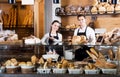 Bakery staff offering bread and different pastry Royalty Free Stock Photo